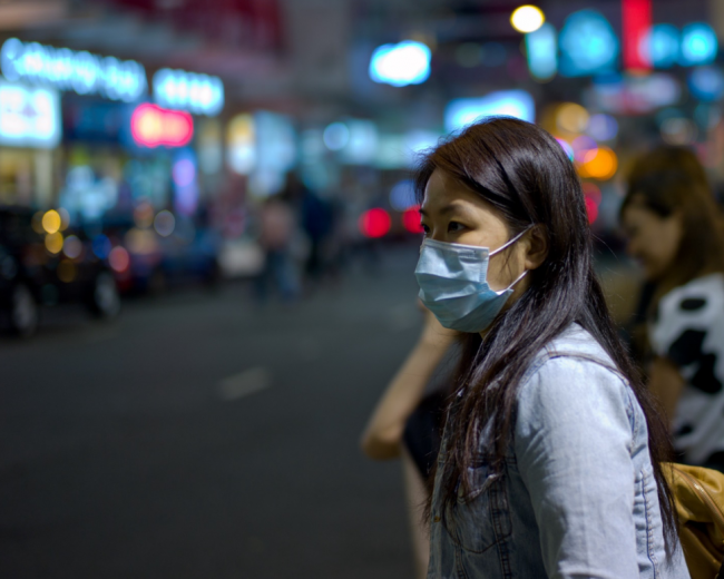 A woman wears a mask to protect against the flue